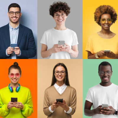 Happy people holding mobile phones in front of a colorblock background