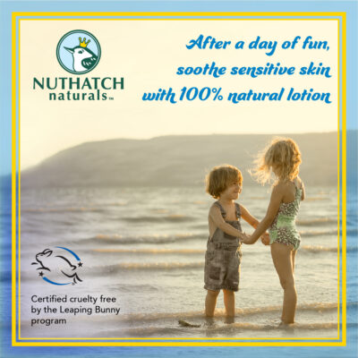 Two children holding hands on the beach and smiling - Nuthatch naturals skin care for kids